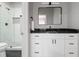 Bathroom showcasing white cabinets, black marble countertop, and an open walk-in shower at 225 Farmbrooke Ct, Sandy Springs, GA 30350