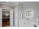 Modern bathroom featuring an illuminated mirror, white cabinets, and a glimpse into the bedroom at 225 Farmbrooke Ct, Sandy Springs, GA 30350