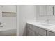 Bathroom with a marble countertop, gray cabinets and a shower with mosaic tile detailing at 225 Farmbrooke Ct, Sandy Springs, GA 30350