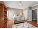 Bedroom with hardwood floors, neutral walls, ceiling fan, and wrought iron bed frame at 225 Farmbrooke Ct, Sandy Springs, GA 30350