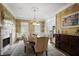 Formal dining room boasts hardwood floors, designer wallpaper, fireplace, and plantation shutters at 225 Farmbrooke Ct, Sandy Springs, GA 30350
