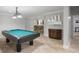 Recreation room features a pool table, bar area, neutral walls, and tile flooring at 225 Farmbrooke Ct, Sandy Springs, GA 30350