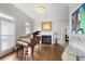 Bright living room features hardwood floors, grand piano, fireplace, and plantation shutters at 225 Farmbrooke Ct, Sandy Springs, GA 30350