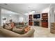 Open living room with large sofa, stone fireplace, built-in bookshelves and access to dining area at 225 Farmbrooke Ct, Sandy Springs, GA 30350
