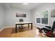 Home office space features hardwood floors, neutral paint, a large window and backyard views at 225 Farmbrooke Ct, Sandy Springs, GA 30350