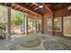 Expansive covered patio with brick accents and ceiling fan, perfect for outdoor relaxation and entertainment at 225 Farmbrooke Ct, Sandy Springs, GA 30350
