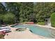 Beautiful backyard pool and spa with lush landscaping, providing a private oasis for relaxation and recreation at 225 Farmbrooke Ct, Sandy Springs, GA 30350
