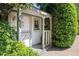 Charming backyard shed with a cozy porch, surrounded by lush greenery and mature landscaping at 225 Farmbrooke Ct, Sandy Springs, GA 30350