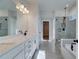 Bright bathroom featuring double vanity, walk-in shower and soaking tub at 4730 Montane St, Cumming, GA 30028