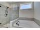 Bright bathroom features a glass shower, soaking tub, and modern black fixtures at 4730 Montane St, Cumming, GA 30028