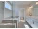 Bright bathroom with glass shower, soaking tub, double vanity, and modern fixtures at 4730 Montane St, Cumming, GA 30028