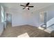 Bright bedroom featuring hardwood floors, ceiling fan, and neutral walls at 4730 Montane St, Cumming, GA 30028