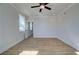 Neutral bedroom with ceiling fan, natural light, and wood-look floors at 4730 Montane St, Cumming, GA 30028