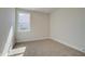 Neutral bedroom with carpet, window and trim detail ready for your personal touch at 4730 Montane St, Cumming, GA 30028