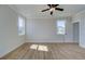 Bright bedroom with neutral walls, ceiling fan, wood floors, and natural light at 4730 Montane St, Cumming, GA 30028