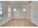 Versatile bonus room with hardwood floors and bright windows with white trim at 4730 Montane St, Cumming, GA 30028