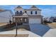 Charming two-story home featuring a brick and white facade, covered porch, and well-manicured lawn at 4730 Montane St, Cumming, GA 30028