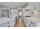 Modern kitchen features white cabinets, stainless steel appliances, and a large center island with a sink at 4730 Montane St, Cumming, GA 30028