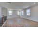 Open living space featuring hardwood floors, modern staircase railing, and large windows for natural light at 4730 Montane St, Cumming, GA 30028