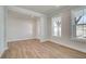 This spacious living room has wood flooring and large windows for natural light at 4730 Montane St, Cumming, GA 30028