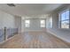Open living area with hardwood floors, modern railing, and large windows for natural light at 4730 Montane St, Cumming, GA 30028