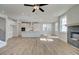 Open-concept floor plan showcasing the modern kitchen, fireplace, wood flooring, and abundant natural light at 4730 Montane St, Cumming, GA 30028