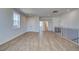 Modern living area with hardwood floors, stairs with black railings, and views of other rooms at 4730 Montane St, Cumming, GA 30028