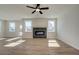 Spacious living area featuring a modern fireplace, wood-look flooring and multiple large windows at 4730 Montane St, Cumming, GA 30028