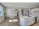 Open living area with an island kitchen, stainless appliances, sleek black fireplace and wood-look floors at 4730 Montane St, Cumming, GA 30028