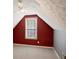 View of attic space featuring red walls with white framed window, white ceiling fan, and gray accents at 5410 Lenox Park Pl, Buford, GA 30518