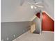 View of the attic featuring gray and terra cotta walls, white ceiling fan and carpeted floors at 5410 Lenox Park Pl, Buford, GA 30518