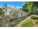 Manicured backyard with a wooden fence, green grass, and tasteful landscaping for outdoor enjoyment at 5410 Lenox Park Pl, Buford, GA 30518
