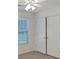 Cozy bedroom featuring a window for natural light and a spacious closet providing ample storage space at 5410 Lenox Park Pl, Buford, GA 30518
