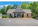 Community clubhouse featuring covered entry and exterior landscaping at 5410 Lenox Park Pl, Buford, GA 30518