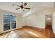 Spacious living room featuring large windows, hardwood floors, and an open layout, offering a warm space at 5410 Lenox Park Pl, Buford, GA 30518