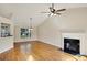 Bright living room with hardwood floors, a fireplace, and ample natural light streaming through a large window at 5410 Lenox Park Pl, Buford, GA 30518