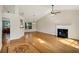 Spacious living room with hardwood floors, a fireplace, and natural light streaming through a large window at 5410 Lenox Park Pl, Buford, GA 30518