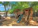 Community playground featuring wooden play structure with slide, ladder and climbing areas at 5410 Lenox Park Pl, Buford, GA 30518
