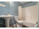 Bathroom with a pedestal sink, tiled floors, and a shower/tub combination at 5870 Buckner Creek Dr, Mableton, GA 30126