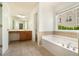 Bright bathroom featuring a soaking tub, vanity, and tile flooring at 5870 Buckner Creek Dr, Mableton, GA 30126