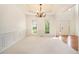 Bright dining room with wainscoting, chandelier, and views to front yard at 5870 Buckner Creek Dr, Mableton, GA 30126