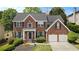 Inviting brick home features lush landscaping, a two-car garage, and classic shutters at 5870 Buckner Creek Dr, Mableton, GA 30126