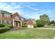 Charming two-story brick home featuring a well-manicured lawn and attached two car garage at 5870 Buckner Creek Dr, Mableton, GA 30126
