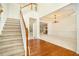 Spacious foyer with hardwood floors, a staircase, and an open view to adjacent rooms at 5870 Buckner Creek Dr, Mableton, GA 30126