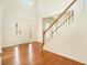 Bright foyer featuring hardwood floors, a staircase, and a front door with sidelights at 5870 Buckner Creek Dr, Mableton, GA 30126