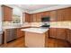 Kitchen with stainless steel appliances, tiled backsplash, and central island at 5870 Buckner Creek Dr, Mableton, GA 30126