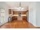 Well-lit kitchen featuring a central island, wooden cabinets, and stainless steel appliances at 5870 Buckner Creek Dr, Mableton, GA 30126