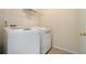 This laundry room features tile flooring and a modern, white, front-load washer and dryer set at 5870 Buckner Creek Dr, Mableton, GA 30126