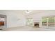 Bright living area with a fireplace, large windows, and neutral carpeting at 5870 Buckner Creek Dr, Mableton, GA 30126