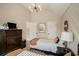 Well-lit bedroom with ample closet space, stylish light fixture, and neutral decor for comfortable living at 812 Nevis Way, Mcdonough, GA 30253